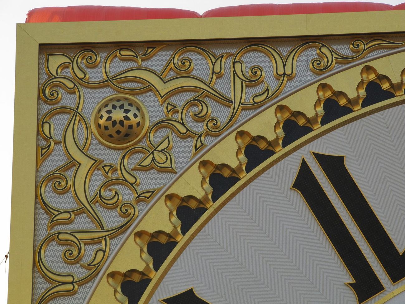 Ornate gold arabesque ceiling border with a carved roundel