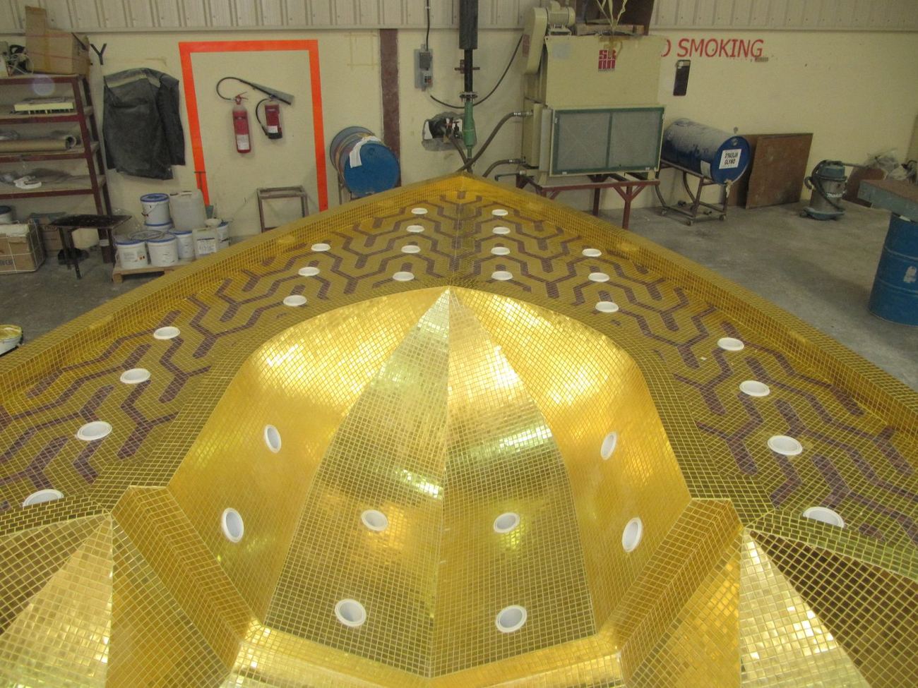 Gold mosaic dome interior with a pattern of inset light fittings