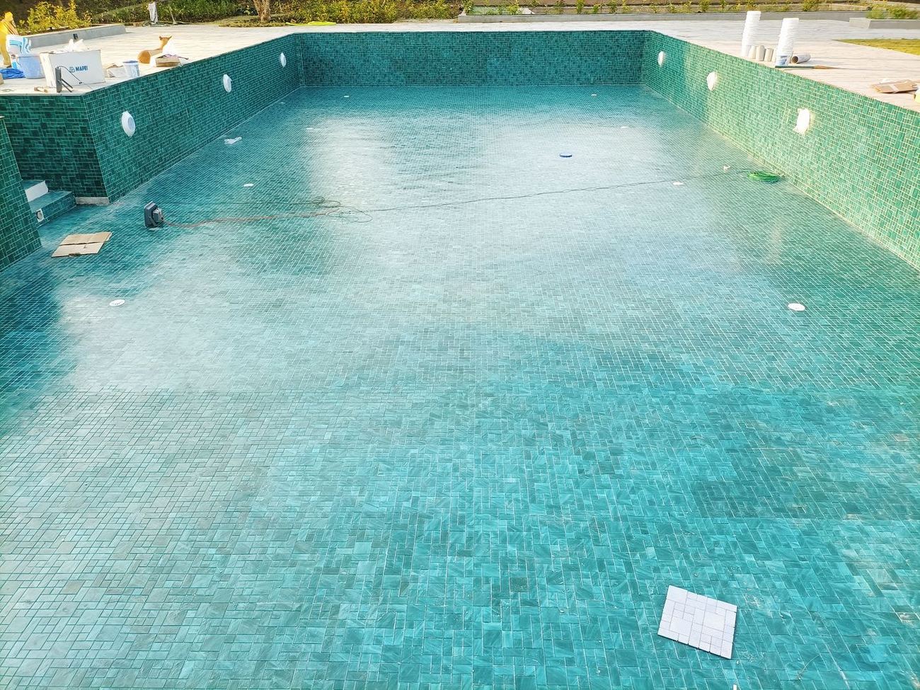 Swimming pool lined in turquoise glass mosaic