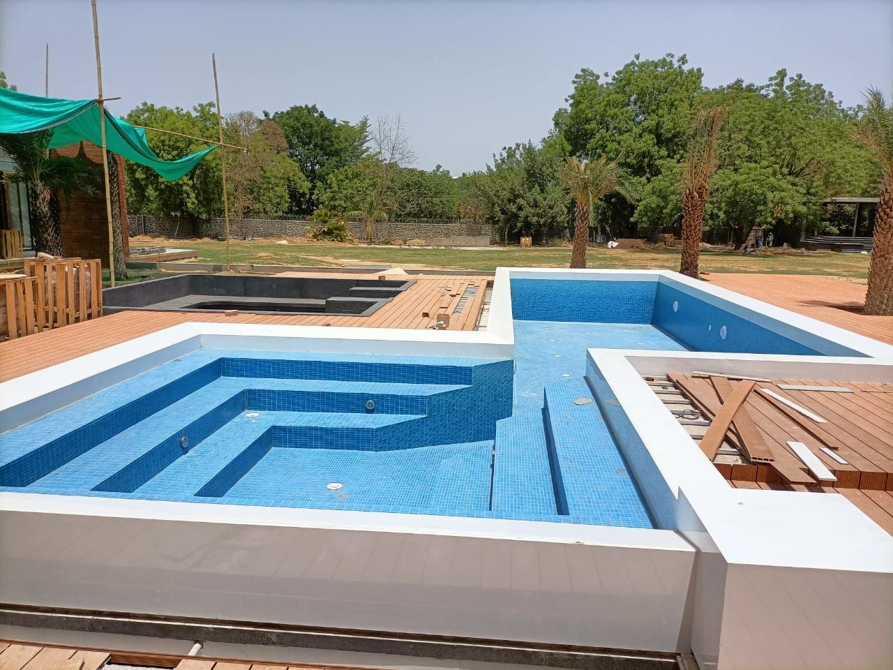 Pool steps lined in mixed green glass mosaic