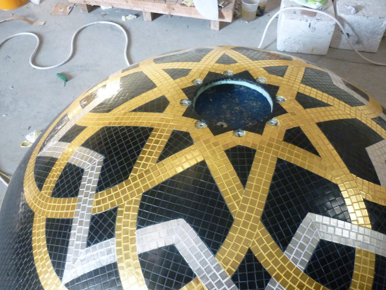 Small dome finished in a black, white and gold geometric star pattern